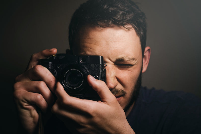 Man photojournalist poses with his photo camera stock photo - OFFSET